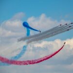 several fighter planes doing smoke exhibition
