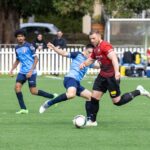 Soccer players competing for the ball on a field