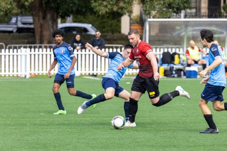 Soccer players competing for the ball on a field